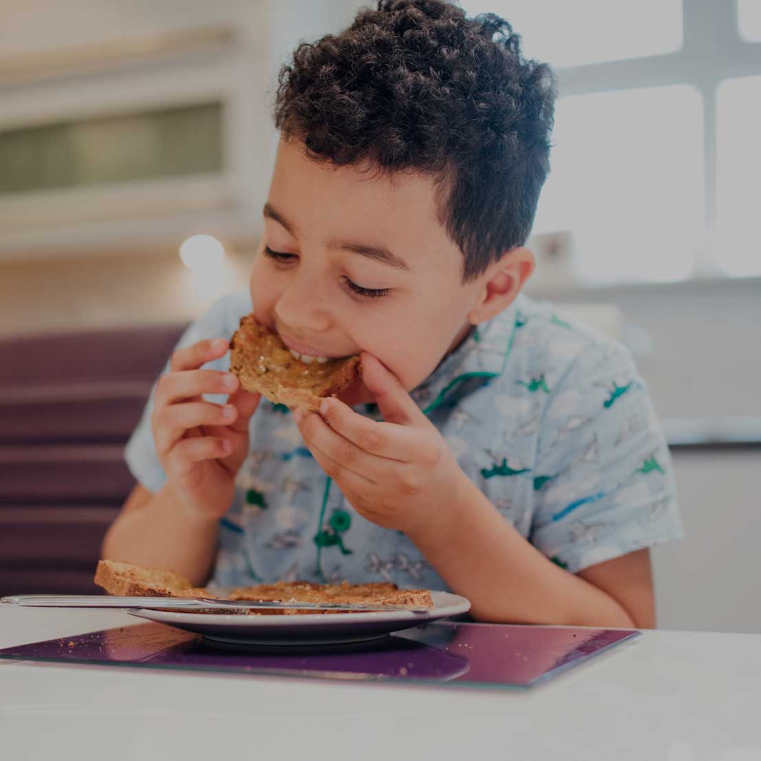 A boy eats toast