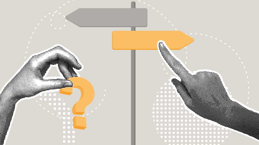A finger points at a signpost pointing in a new direction while another hand holds a question mark