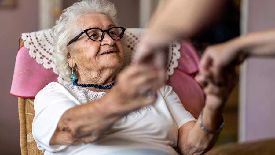 An elderly woman sitting in a chair