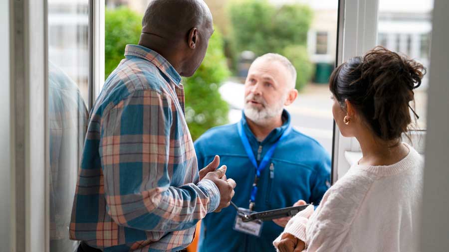 Housing officer talks to a couple of their doorstep