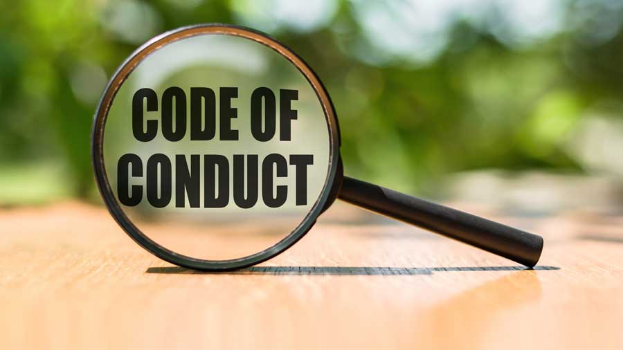 A magnifying glass over the words 'Code of Conduct'