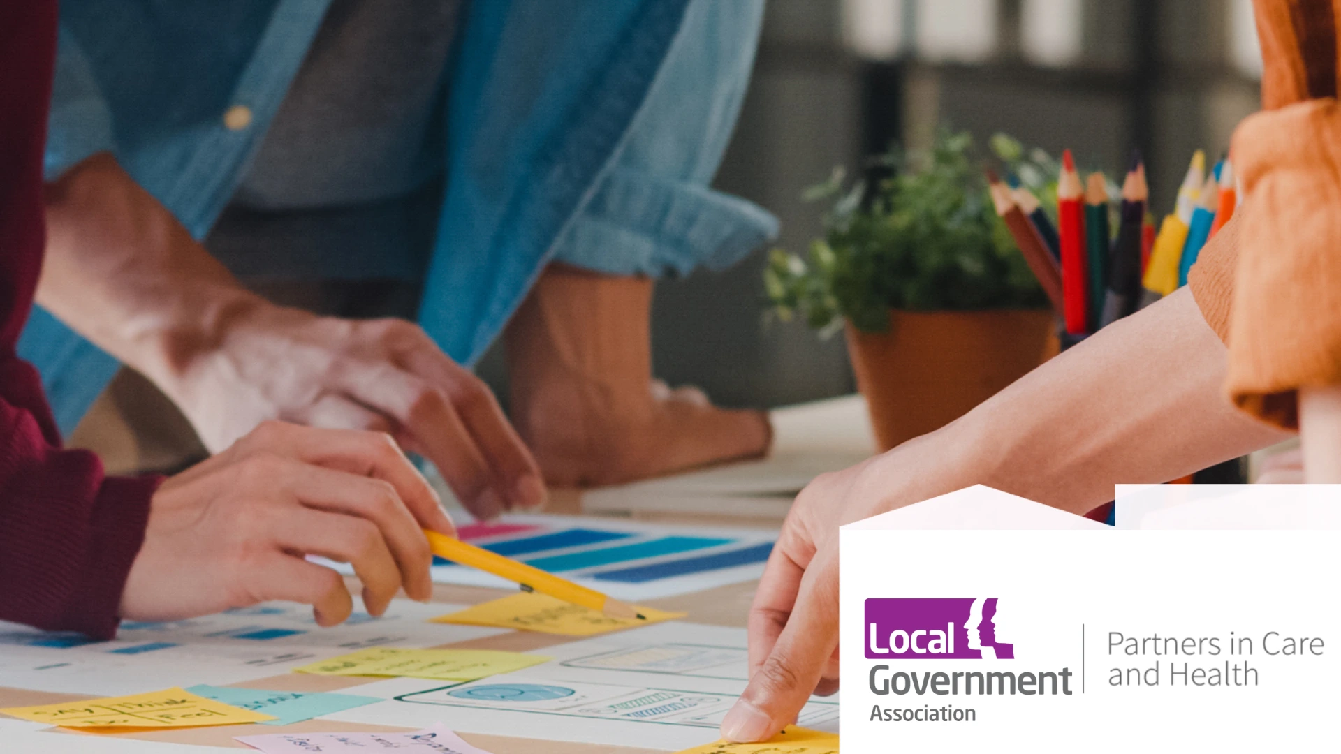 People planning with post it notes and mind map. with the Local Government Association and Partners in Care and Health logo in right hand corner.