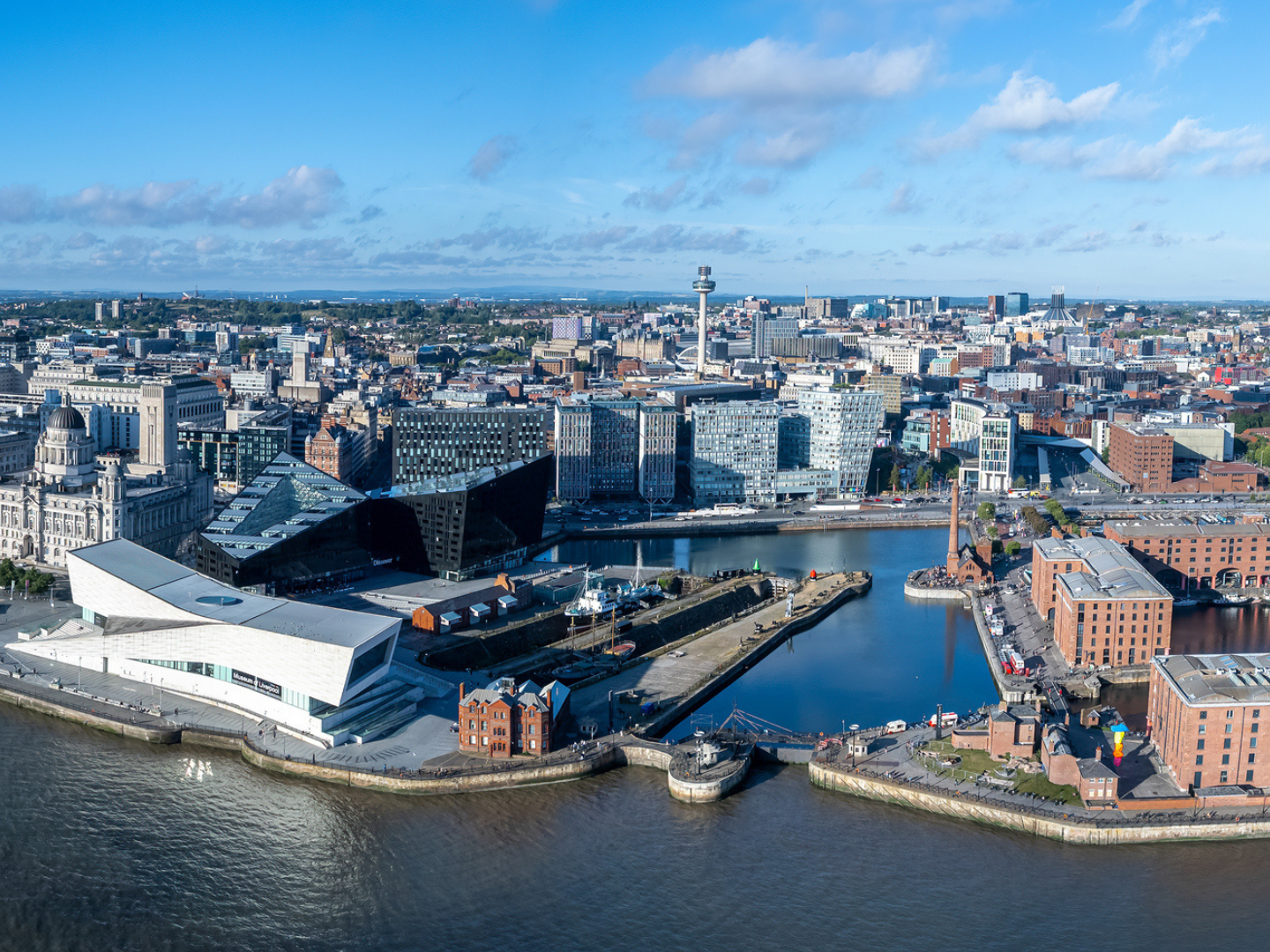 The drone aerial view of Liverpool with Mersey river in foreground.